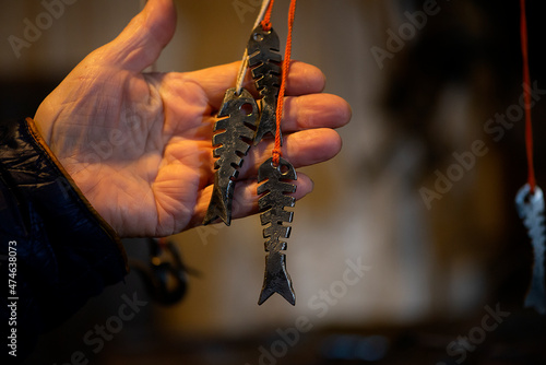 Blacksmith decorative elements metal fish hanging at forge, workshop. Handmade, craftsmanship and blacksmithing concept
