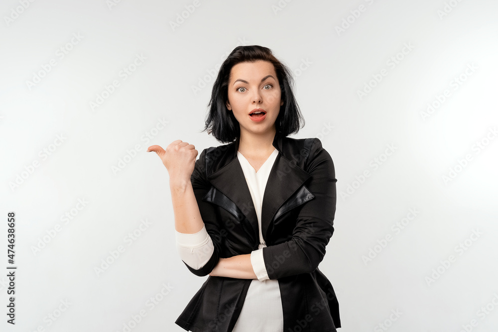 Pretty woman looking surprised, pointing aside at left copy space, presenting your product, recommend follow link, click on banner, standing over white background Pretty woman looking surprised, pointing aside at left copy space, presenting your product, recommend follow link, click on banner, standing over white background