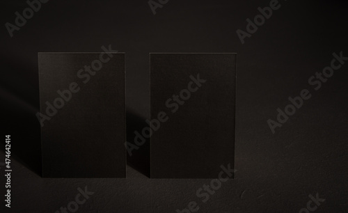 Black mock up business card for branding on grey rustic background .