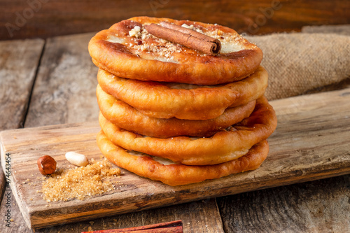 Traditional dessert of fried dough stuffed with nuts and sugar on a wooden board for serving. Street food in South Korea.