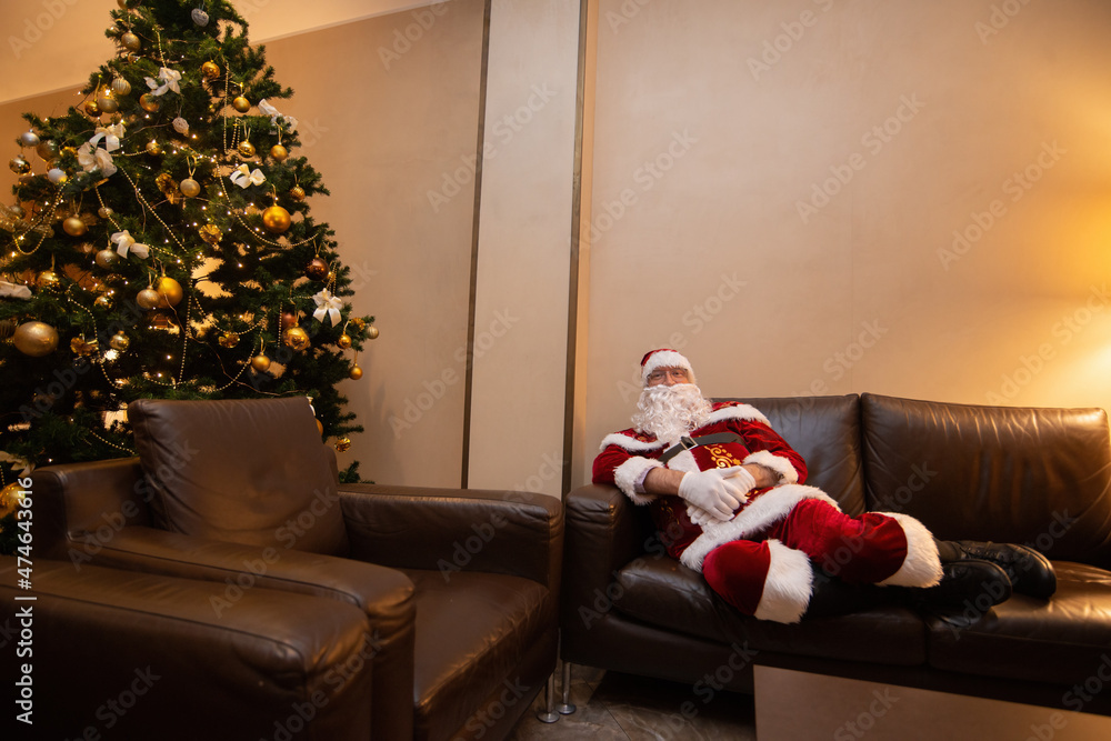 Fototapeta premium Santa Claus relaxing on the couch