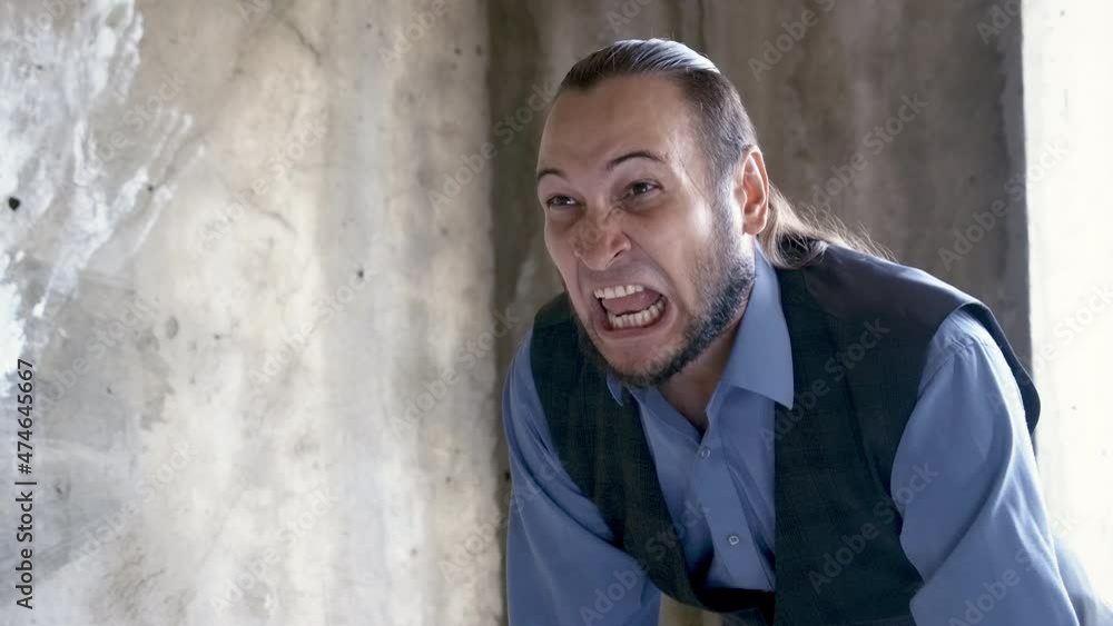 Angry screaming man in abandoned building Angry screaming man in abandoned building