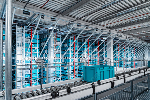Container on conveyor belt at automated warehouse photo