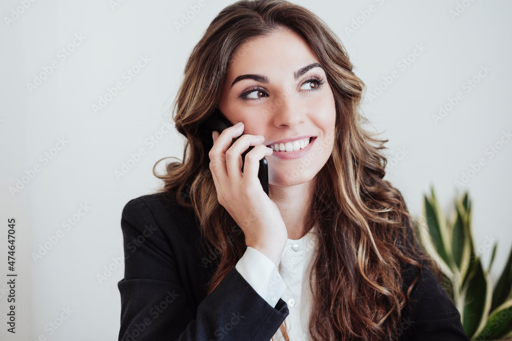 Contemplating businesswoman talking on smart phone Contemplating businesswoman talking on smart phone