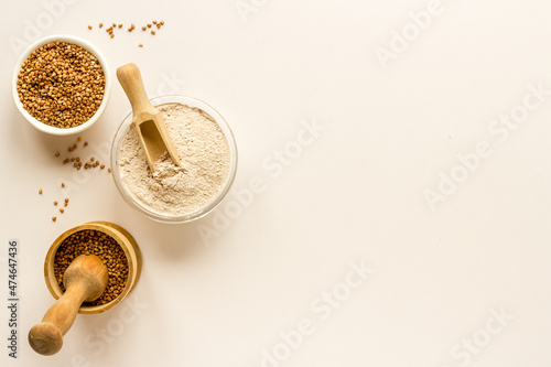 Pestle buckwheat flour - grains with mortar on kitchen table