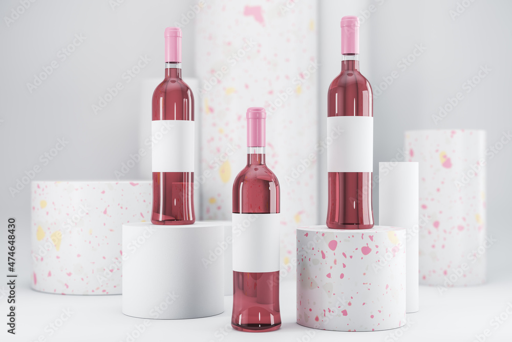 Pink rose wine bottle with empty mock up label on white backdrop