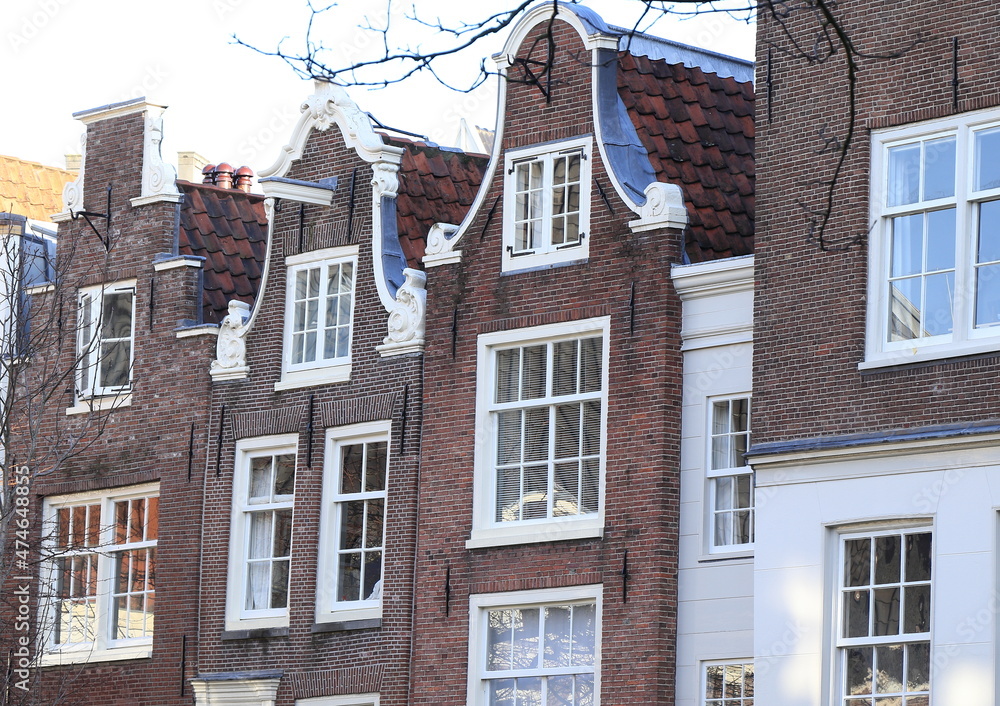 Traditional Brown Brick House Facades with Bell Gables at the Begijnhof Courtyard in Amsterdam, Holland Traditional Brown Brick House Facades with Bell Gables at the Begijnhof Courtyard in Amsterdam, Holland