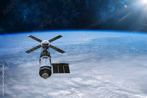 Fototapeta Naklejka Na Ścianę i Meble -  Cargo space craft Earth planet.Dark background. Sci-fi wallpaper.Space Station Orbiting Earth.Space ship.Space art wallpaper.Solar Observatory.Elements of this image furnished by NASA.3D illustration