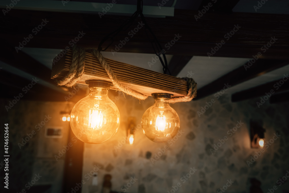 Vintage incandescent so called Edison bulbs in decorative lamps in retro styled interior.