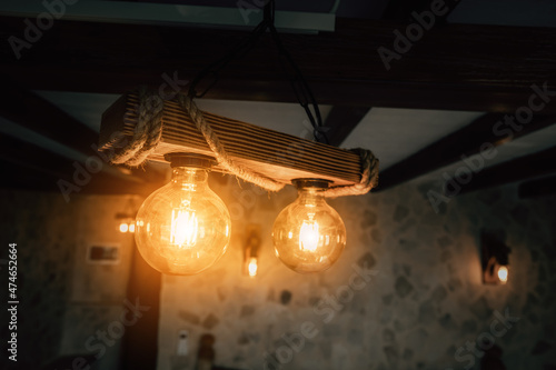 Vintage incandescent so called Edison bulbs in decorative lamps in retro styled interior.