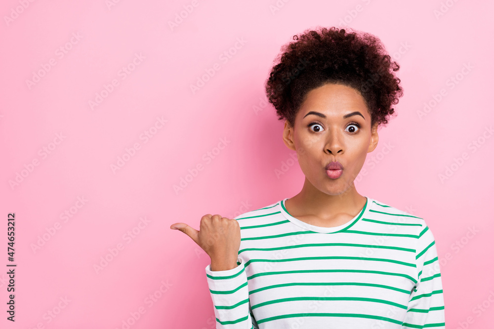 Photo of flirty bun hairdo young lady index empty space wear white shirt isolated on pink color background Photo of flirty bun hairdo young lady index empty space wear white shirt isolated on pink color background