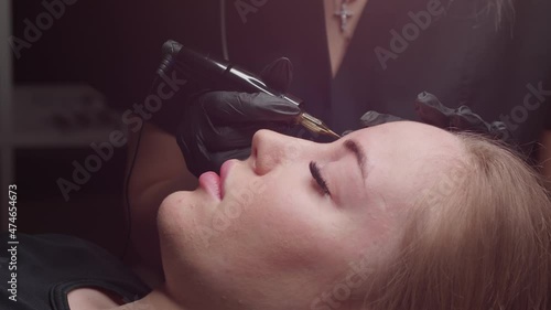 Close-up of tattooing on the eyebrows of a young girl