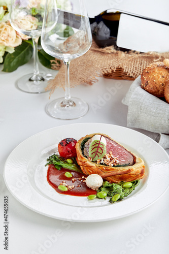 Meat roll sliced on a dish with vegetables on a festive table