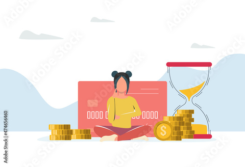 The girl sits near a lot of money and a credit card with an hourglass money. Businesswoman concept
