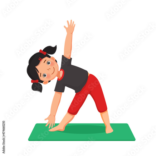 Little girl doing gymnastic fitness exercises practicing yoga pose on a green mat indoor at home