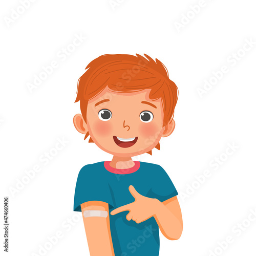 Cute little boy showing sticking patch or plaster on his arm after got Vaccine Injection and giving thumb up gestures with smiling facial expression