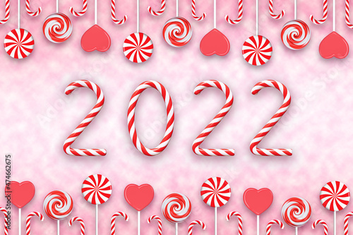 The inscription 2022 from red and white Christmas candies on the background of lollipops and hearts. 3D rendering and 3D illustration.