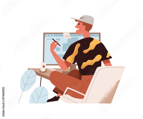 Happy man work at desktop computer. Creative employee at modern workplace wit...