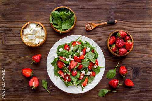 Vegan meal - spinach salad with strawberry and goat cheese