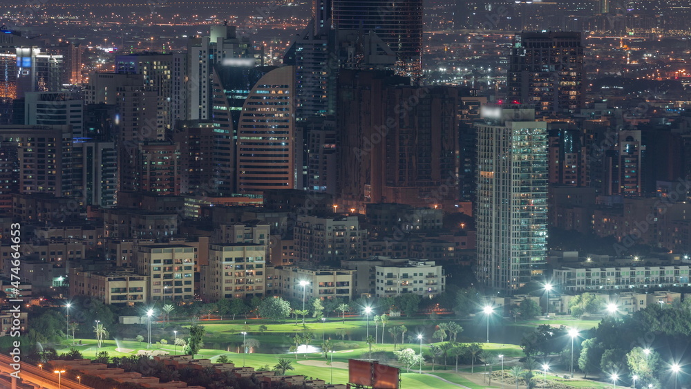 Obraz premium Aerial view of greens and al barsha heights district area night timelapse from Dubai marina.