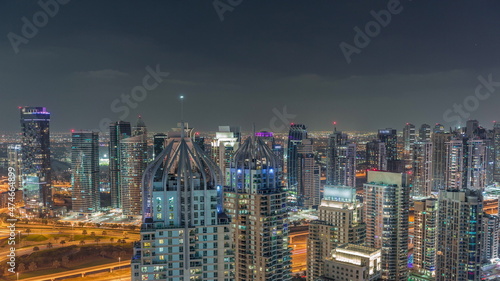 Dubai marina and JLT skyscrapers along Sheikh Zayed Road aerial night timelapse.