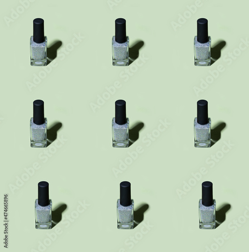 Silver nail polish pattern on basil green background