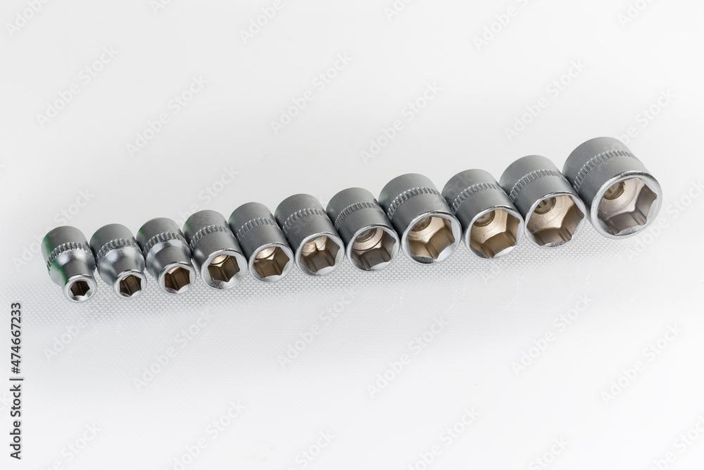 Set of the hexagonal sockets different sizes on light surface Set of the hexagonal sockets different sizes on light surface