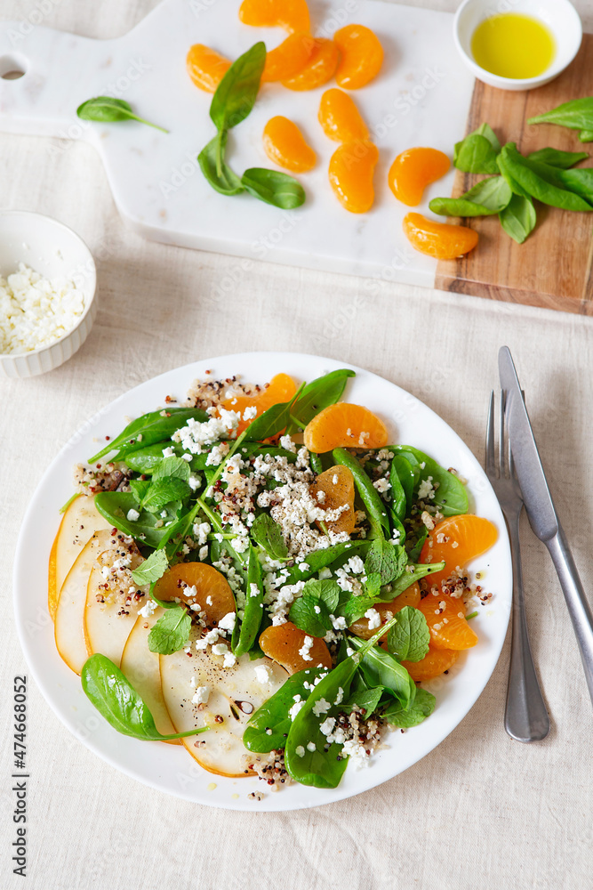 Spinach and quinoa salad with pears, oranges and ricotta. Healthy Meal prep. Plant-based dishes. Green living. Vegan recipe. Food styling. Vegetarian cuisine. Healthy eating. Weight loss food.