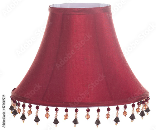 classic cut corner bell shaped burgundy deep red lampshade with a beaded fringe on a white background isolated close up shot 