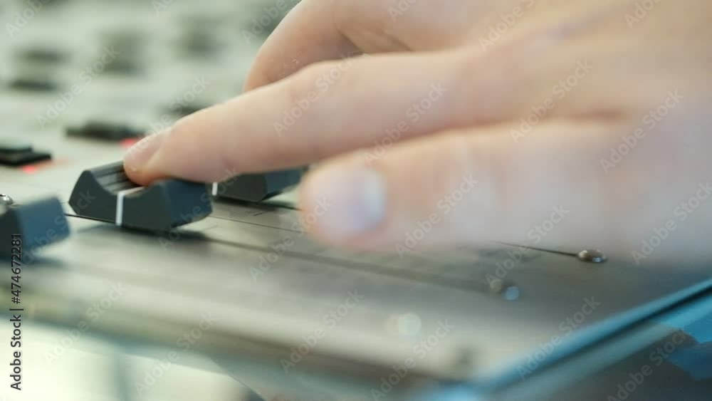 A close up of an audio console with three sliders moved by three fingers. radio station, Israel. A close up of an audio console with three sliders moved by three fingers. radio station, Israel.