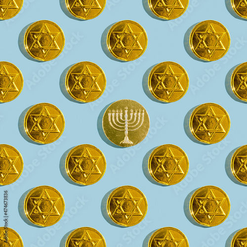 Seamless pattern with Hanukkah chocolate coins on blue background. photo