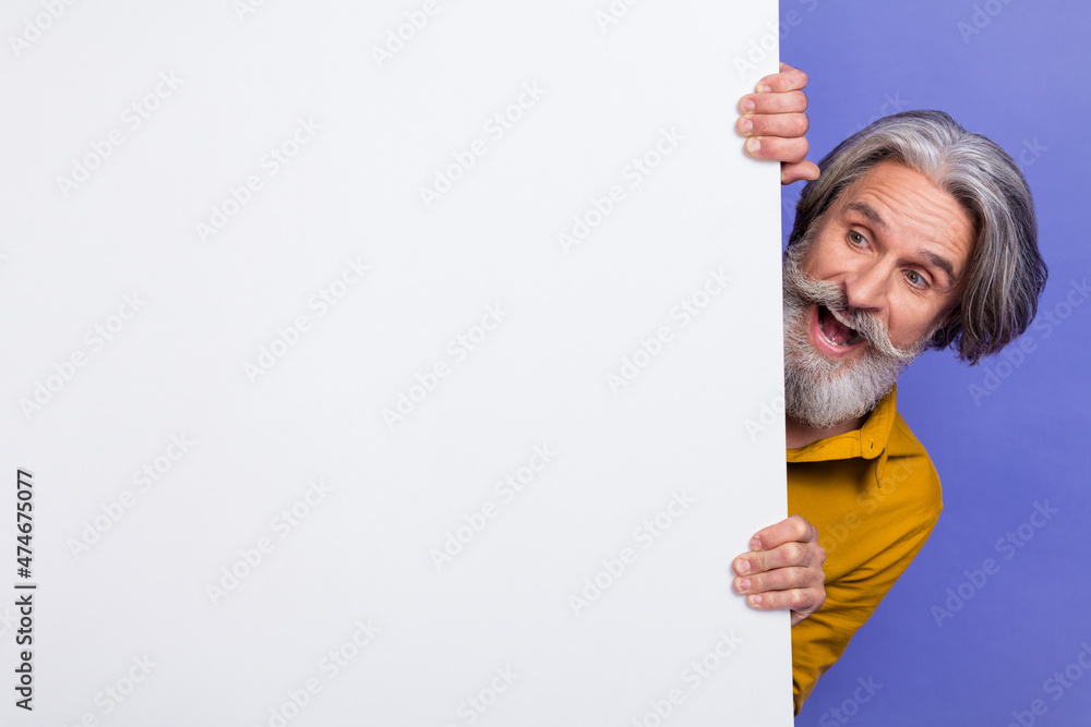 Portrait of attractive amazed cheerful gray-haired man holding copy blank space promo isolated over bright violet purple color background Portrait of attractive amazed cheerful gray-haired man holding copy blank space promo isolated over bright violet purple color background