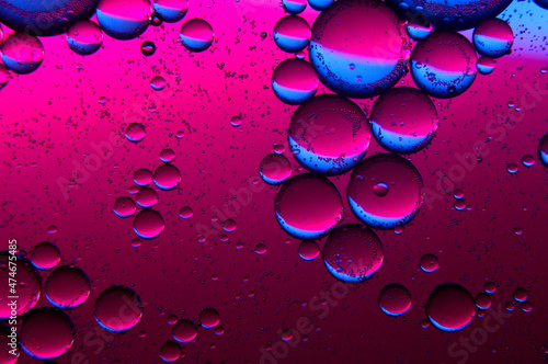 abstract background. drops of oil on water, blue and red. macro