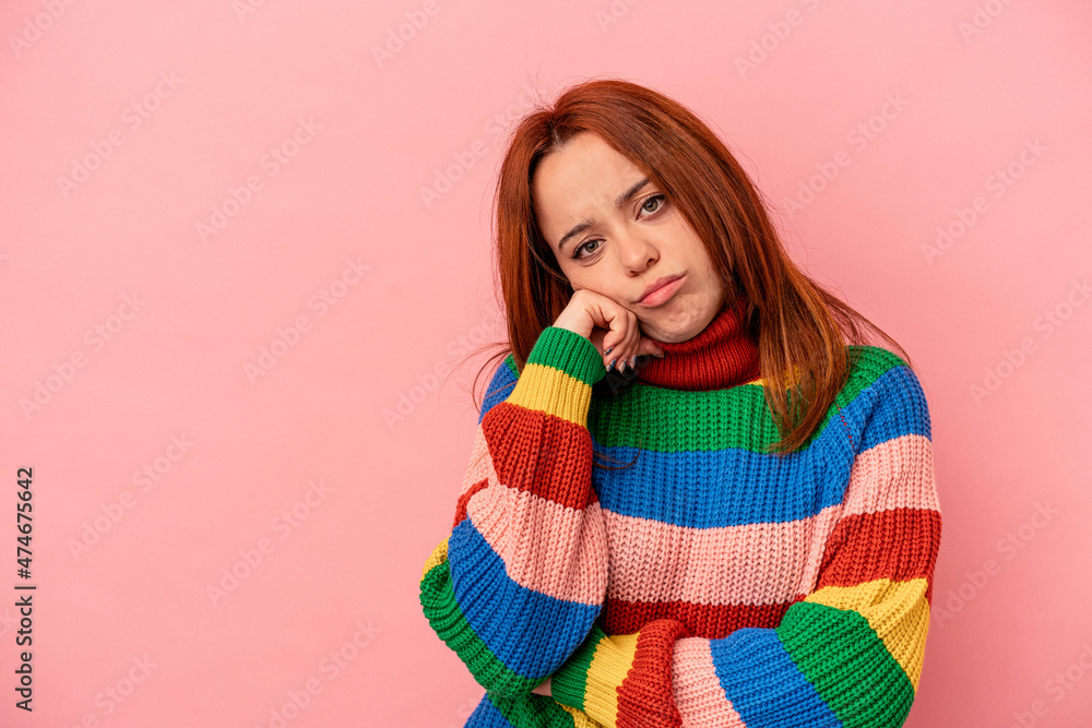 Young caucasian woman isolated on pink background who feels sad and pensive, looking at copy space. Young caucasian woman isolated on pink background who feels sad and pensive, looking at copy space.