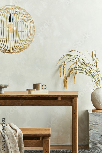 Elegant dining room interior composition with wooden dining table, bench and design home deocrations and personal accessories. Modern home staging. Wabi sabi inspiration. Template. . photo