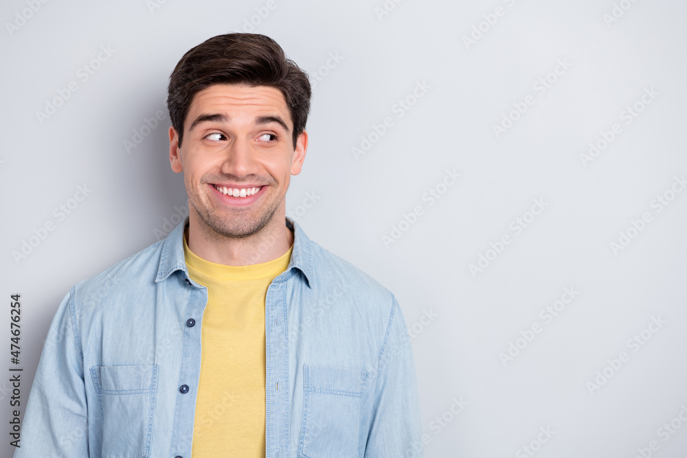 Photo of confident attractive young guy dressed denim shirt looking empty space isolated grey color background Photo of confident attractive young guy dressed denim shirt looking empty space isolated grey color background