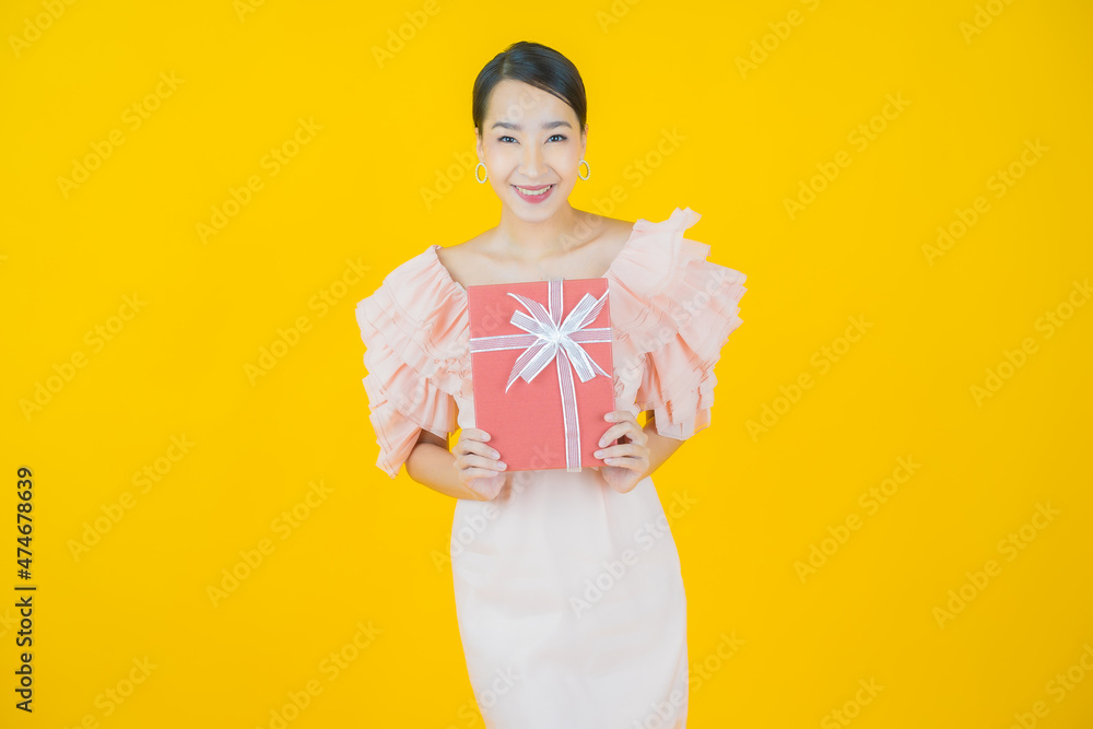 Portrait beautiful young asian woman smile with red gift box