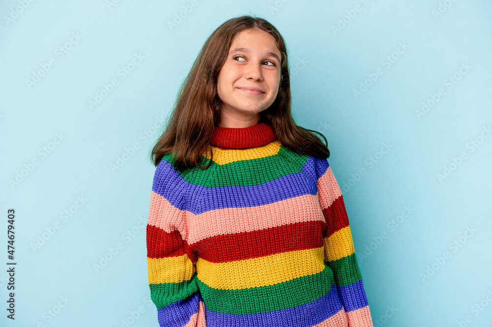 Little caucasian girl isolated on blue background dreaming of achieving goals and purposes Little caucasian girl isolated on blue background dreaming of achieving goals and purposes