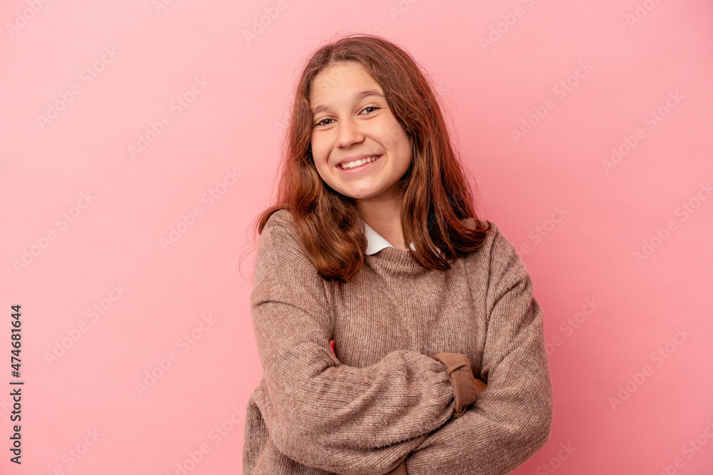 Little caucasian girl isolated on pink background who feels confident, crossing arms with determination. Little caucasian girl isolated on pink background who feels confident, crossing arms with determination.