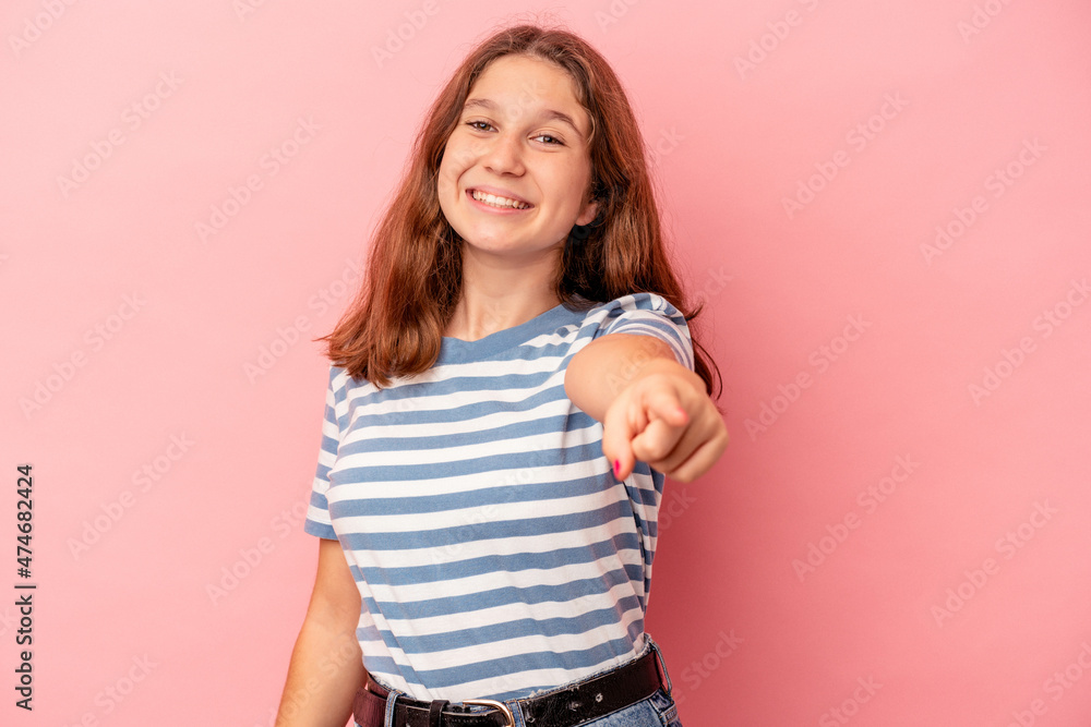 Little caucasian girl isolated on pink background cheerful smiles pointing to front. Little caucasian girl isolated on pink background cheerful smiles pointing to front.