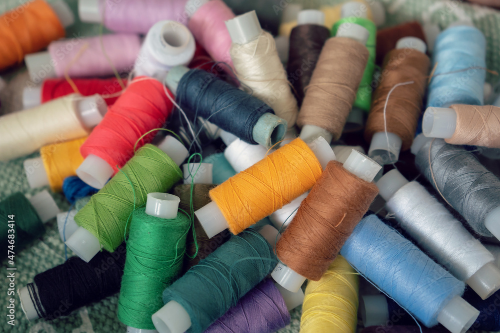 Sewing threads as a multicolored background. High angle view of colored threads for tailor job Sewing threads as a multicolored background. High angle view of colored threads for tailor job