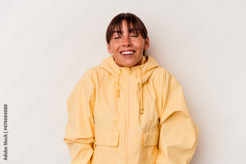 Young Argentinian woman isolated on white background laughs and closes eyes, feels relaxed and happy.