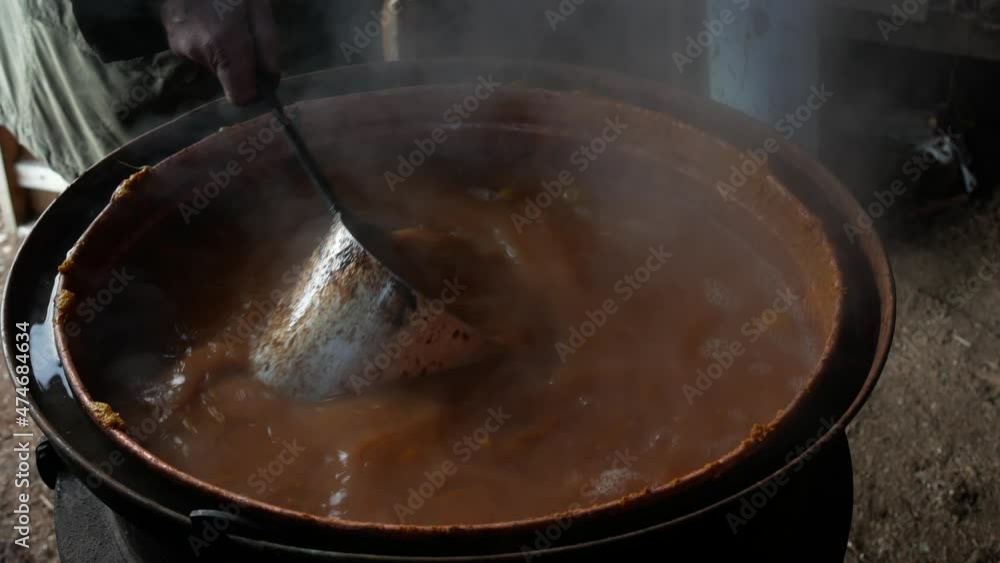 Production of plum brandy in the traditional way. Mixing of hot