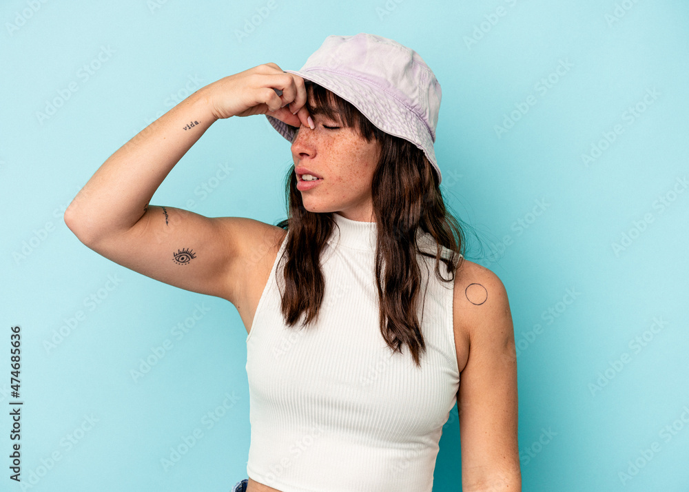 Young Argentinian woman isolated on blue background having a head ache, touching front of the face. Young Argentinian woman isolated on blue background having a head ache, touching front of the face.