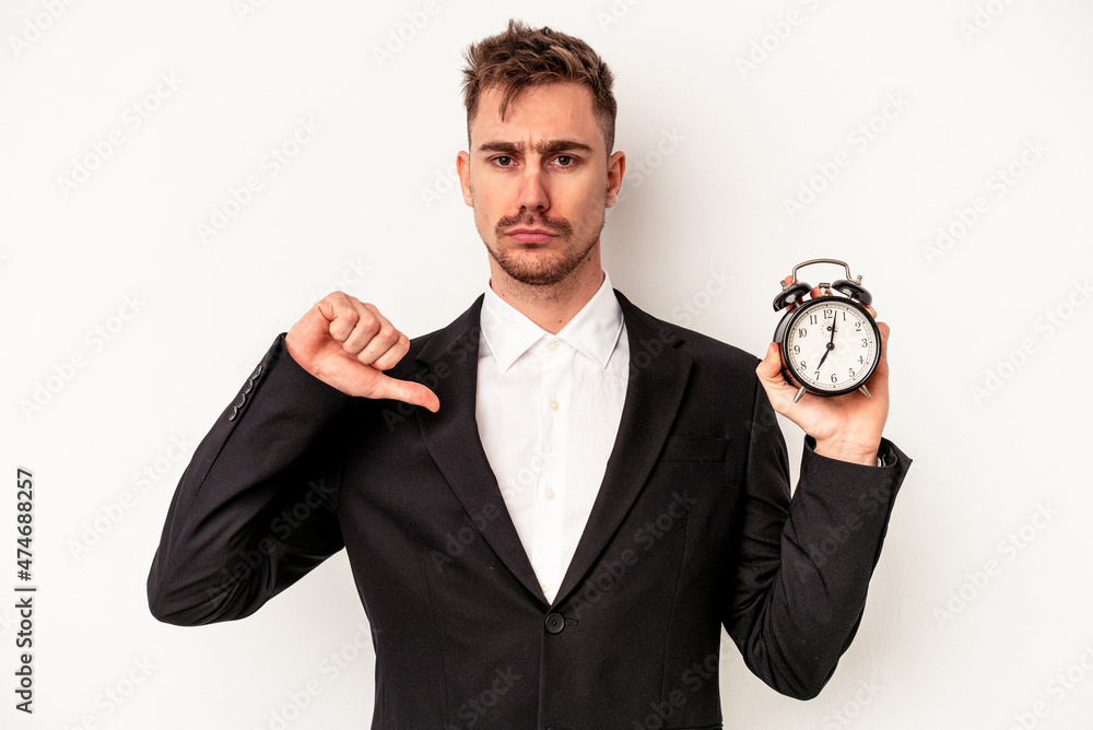 Young caucasian business man holding alarm clock isolated on white background feels proud and self confident, example to follow. Young caucasian business man holding alarm clock isolated on white background feels proud and self confident, example to follow.
