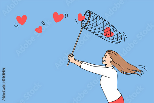 Searching for love and romance concept. Young positive girl running trying to collect flying red hearts in net over blue air background vector illustration 