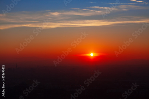 Sunset over the city and mountains . Spectacular orange twilight . Silhouette of the mountains on the horizon © russieseo