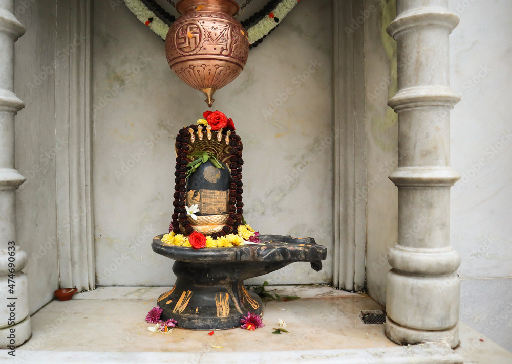 A Close up picture of a Shiva Lingam made of stone material with a