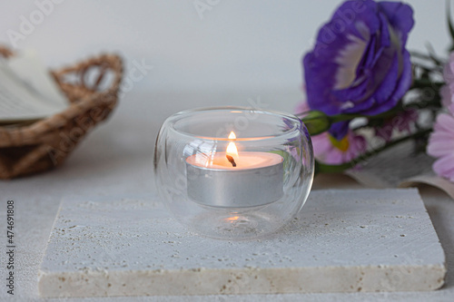 Fotografie Burning Tea Lights on a white surface.