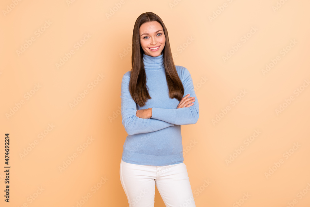 Photo of positive pretty person crossed arms beaming smile look camera isolated on beige color background Photo of positive pretty person crossed arms beaming smile look camera isolated on beige color background